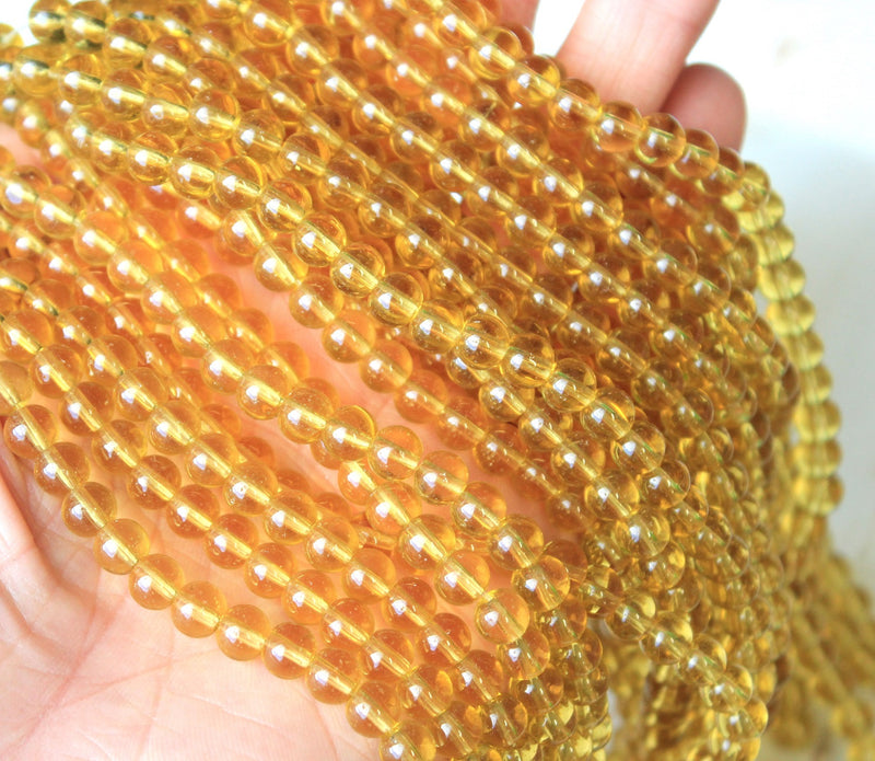 1 Strand of 6mm Glass Beads ~ Transparent Light Gold ~ approx. 50 beads
