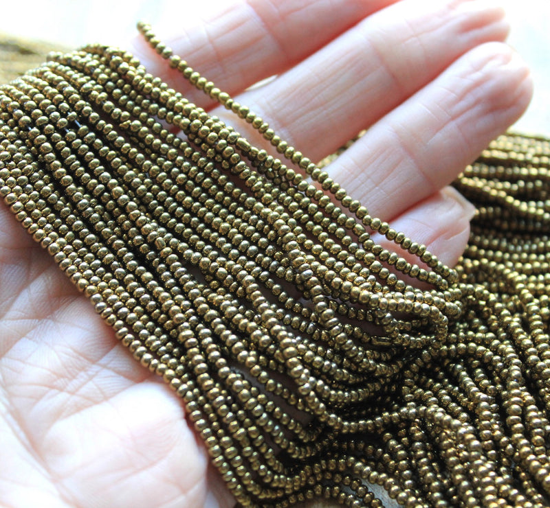 The Bead Store 2mm Seed Beads (Not Uniform) Metallic Old Gold 12 String/Hank