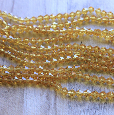 The Bead Store 6mm Glass Bicones Gold 